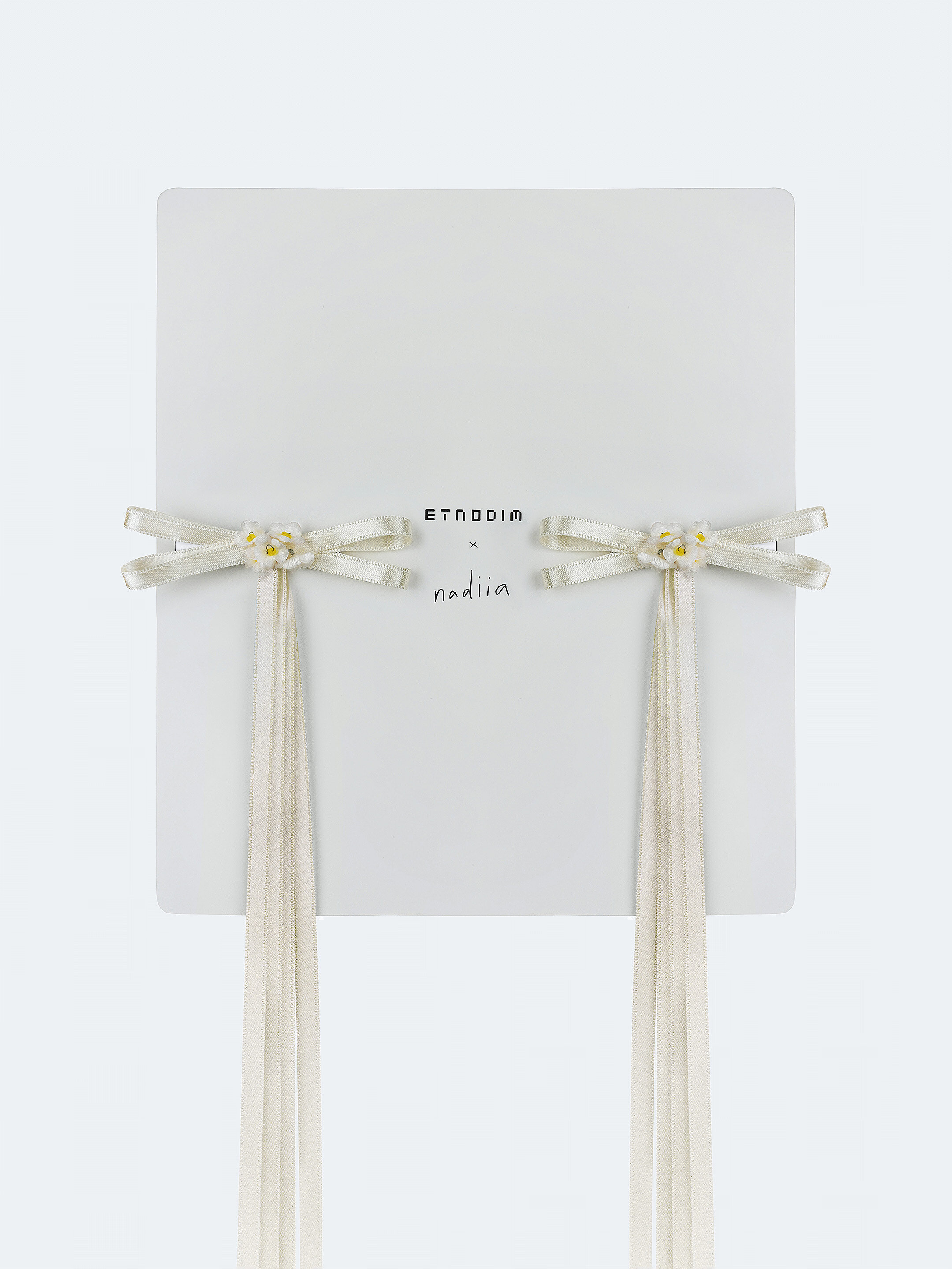 A pair of ribbons-barrettes of milk color "Tsarivna" in Ukraine