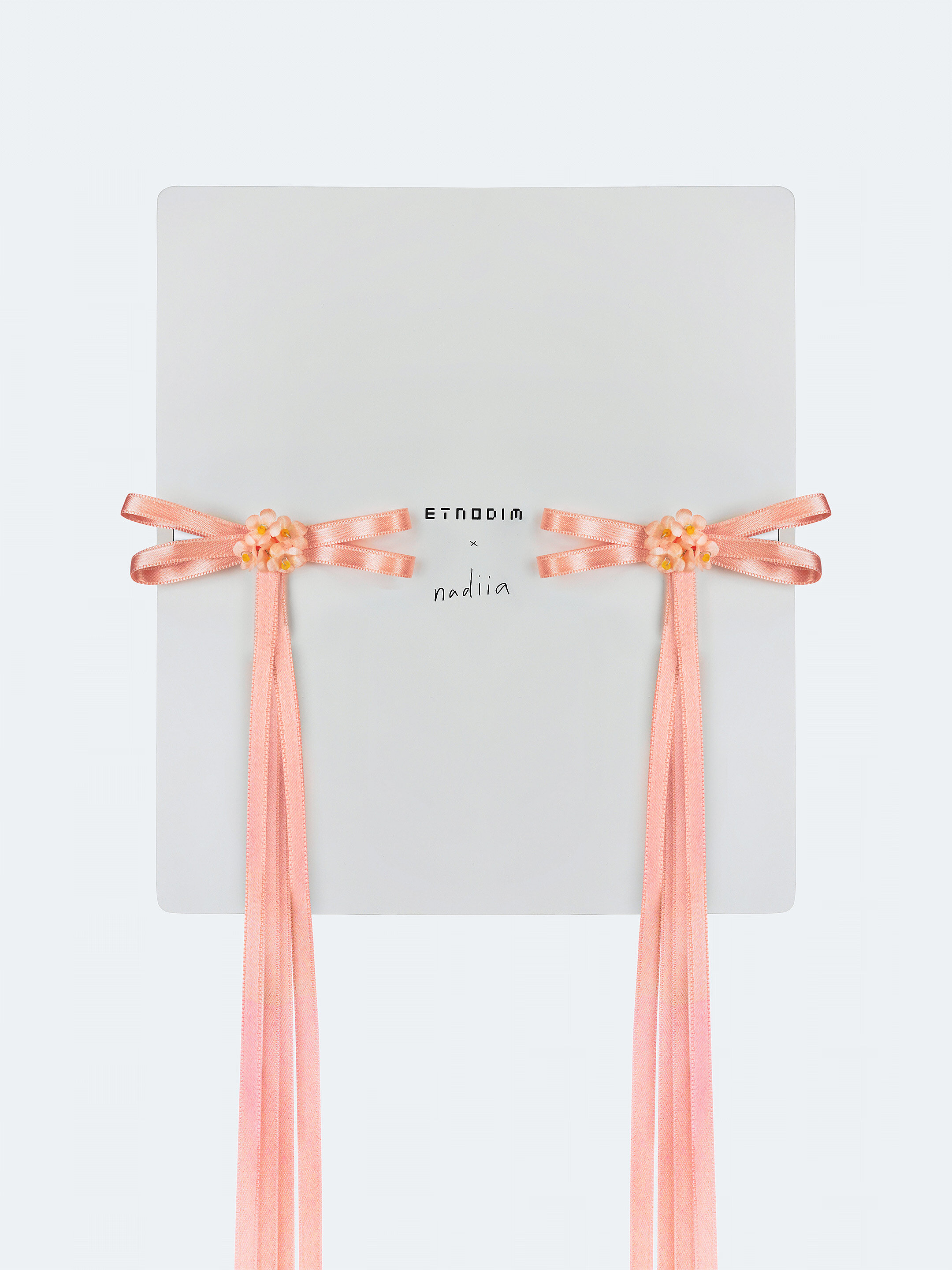 A pair of ribbons-barrettes of peach color "Tsarivna" in Ukraine