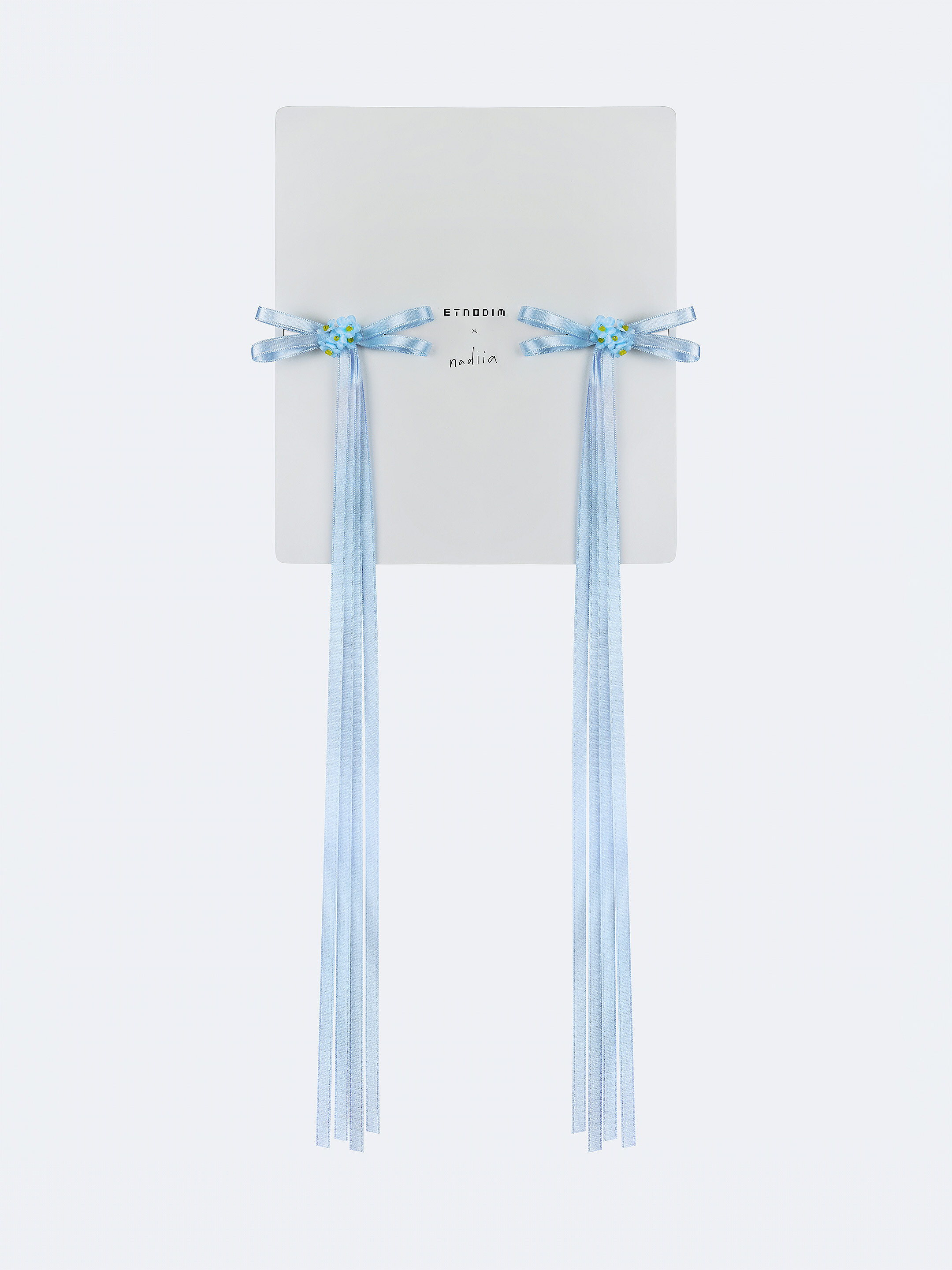 A pair of ribbons-barrettes of white color "Tsarivna" in Ukraine